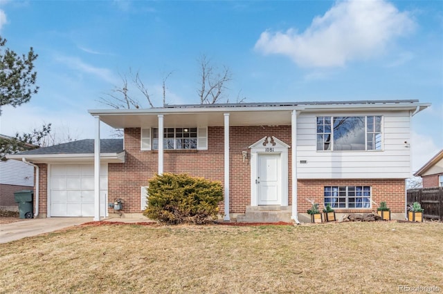 raised ranch featuring driveway, a garage, fence, a front lawn, and brick siding