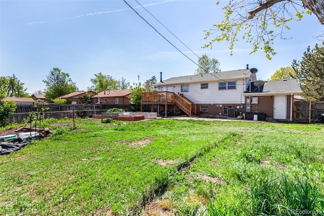 1081 E 119th Pl, Northglenn, CO 80233 - fenced backyard featuring a garden, a wooden deck, stairway, and a patio area