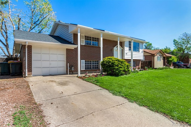 1081 E 119th Pl, Northglenn, CO 80233 - view of front of home with brick siding, a garage, and a front yard