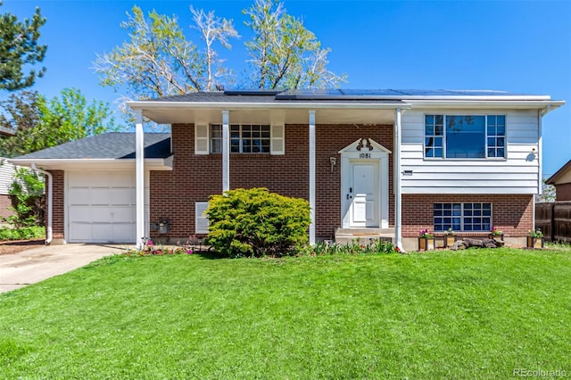 1081 E 119th Pl, Northglenn, CO 80233 - raised ranch featuring an attached garage, brick siding, solar panels, and concrete driveway