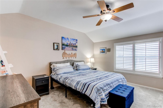 bedroom with vaulted ceiling, carpet flooring, baseboards, and a ceiling fan