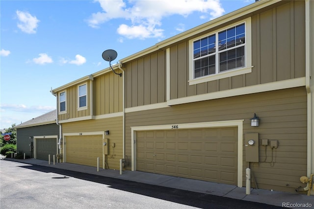 view of home's exterior with board and batten siding and a garage