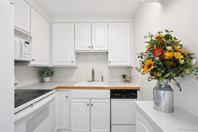 1155 N Ash St Unit 1204, Denver, CO 80220 - kitchen featuring white appliances, white cabinets, light countertops, and tasteful backsplash