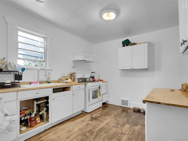 1561 Clinton St, Aurora, CO 80010 - kitchen with white range with gas stovetop, under cabinet range hood, white cabinetry, wood finished floors, and light countertops