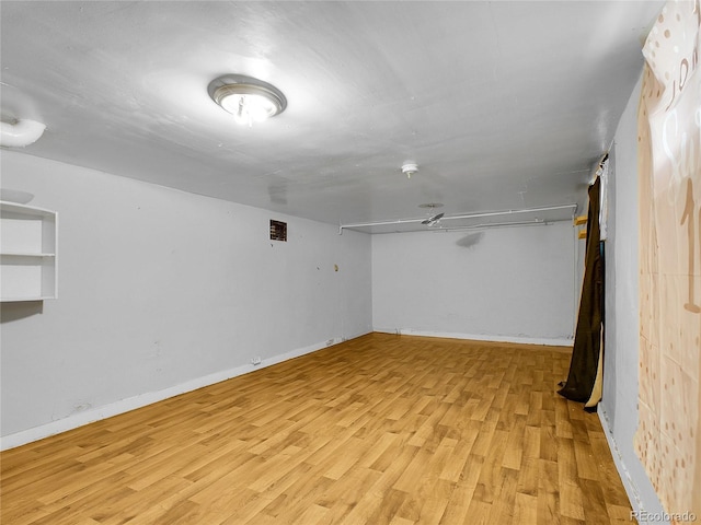 1561 Clinton St, Aurora, CO 80010 - finished below grade area featuring light wood-style flooring and baseboards