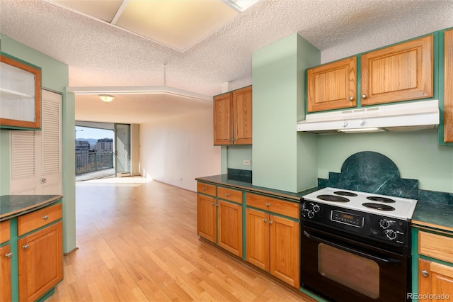 kitchen with white range with electric stovetop, a textured ceiling, and light wood-type flooring