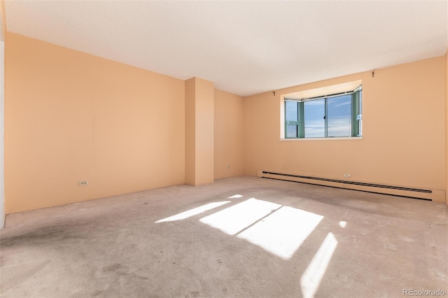 unfurnished room featuring carpet floors and a baseboard radiator