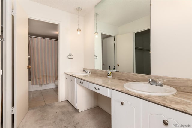 bathroom with tile patterned flooring, vanity, and toilet