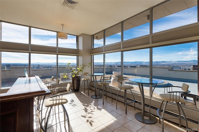 sunroom / solarium featuring a mountain view and a baseboard radiator