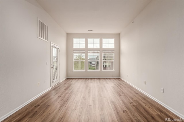 empty room featuring wood finished floors and baseboards
