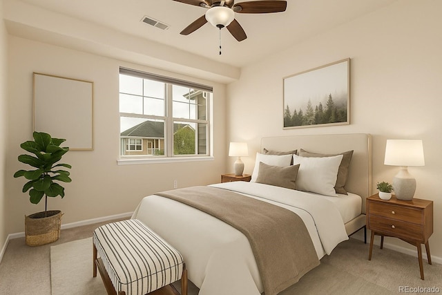 bedroom with light colored carpet, baseboards, and a ceiling fan