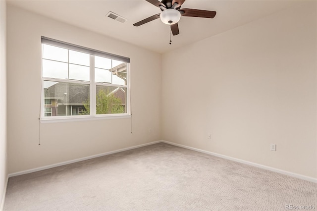 carpeted spare room with baseboards and ceiling fan