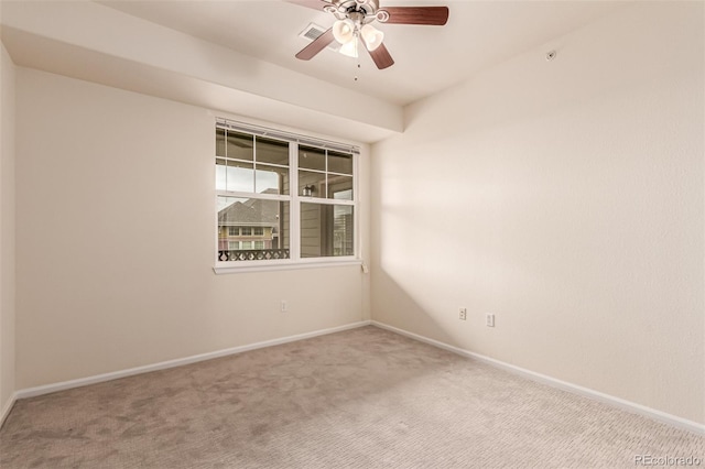 empty room with carpet floors, baseboards, and a ceiling fan