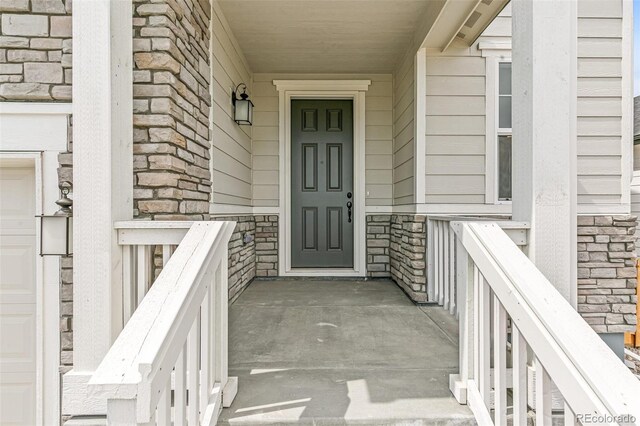 doorway to property featuring stone siding