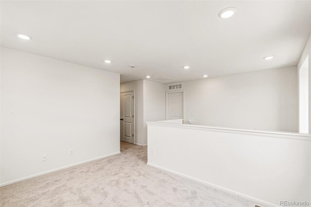 unfurnished room featuring baseboards, recessed lighting, visible vents, and light carpet