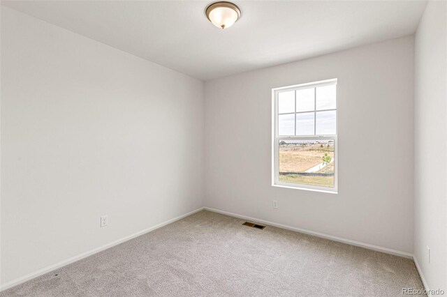 carpeted empty room with baseboards and visible vents