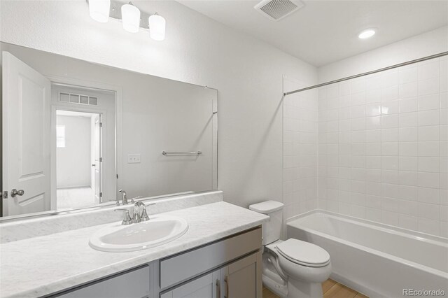 full bath with visible vents, shower / washtub combination, toilet, and vanity