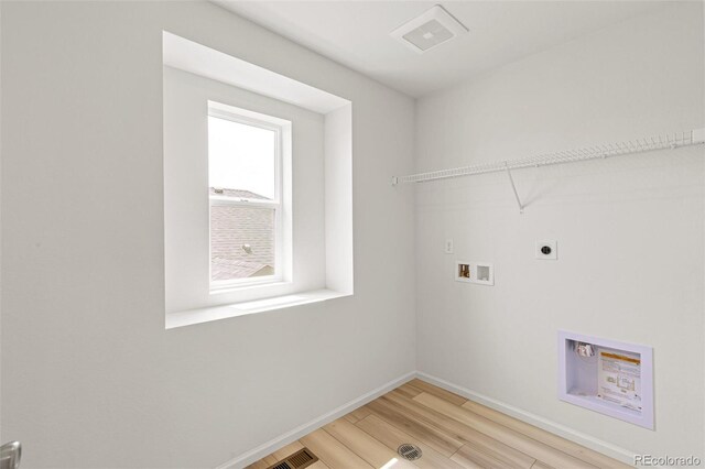 washroom with visible vents, washer hookup, light wood-style flooring, hookup for an electric dryer, and laundry area