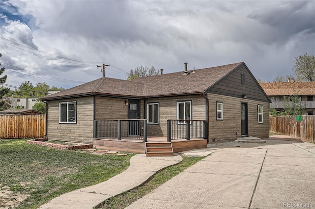 6000 Yarrow St, Arvada, CO 80004 - view of front of home with fence, a shingled roof, and a front yard
