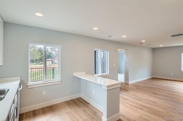 6000 Yarrow St, Arvada, CO 80004 - kitchen with light wood finished floors, light countertops, recessed lighting, baseboards, and visible vents