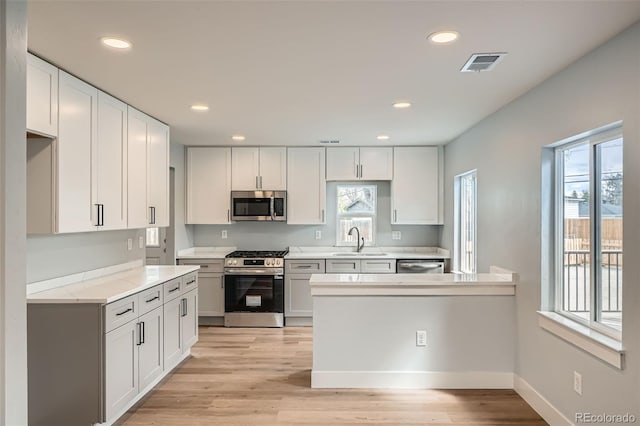 6000 Yarrow St, Arvada, CO 80004 - kitchen with a sink, appliances with stainless steel finishes, recessed lighting, and visible vents