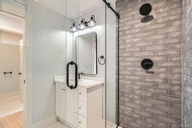 6000 Yarrow St, Arvada, CO 80004 - bathroom featuring baseboards, tiled shower, and vanity