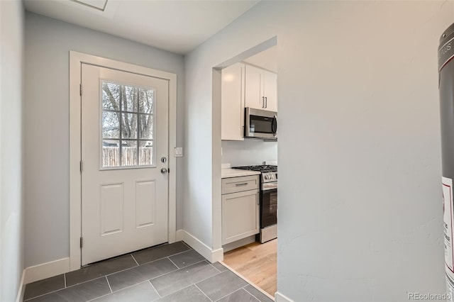 6000 Yarrow St, Arvada, CO 80004 - doorway to outside featuring light tile patterned floors and baseboards