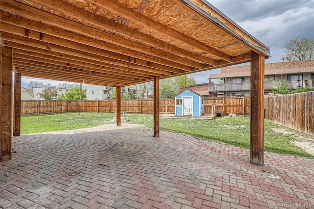6000 Yarrow St, Arvada, CO 80004 - view of patio with a fenced backyard, an outbuilding, and a storage shed