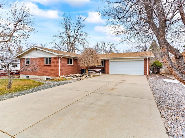 ranch-style home featuring a garage, driveway, and brick siding