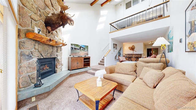 404 Gcr 834 Unit 5, Fraser, CO 80442 - living area with carpet, a towering ceiling, stairway, a fireplace, and beamed ceiling