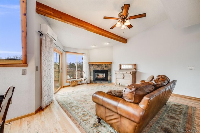 163 Ward Ct, Lakewood, CO 80228 - living room featuring a wall mounted AC, beam ceiling, baseboards, light wood-type flooring, and ceiling fan