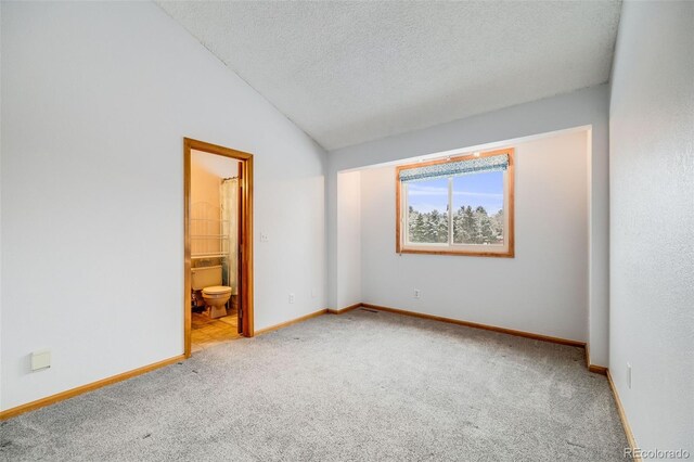 163 Ward Ct, Lakewood, CO 80228 - carpeted spare room with baseboards, vaulted ceiling, and a textured ceiling