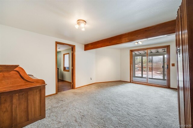 163 Ward Ct, Lakewood, CO 80228 - unfurnished room with carpet flooring, baseboards, and beam ceiling