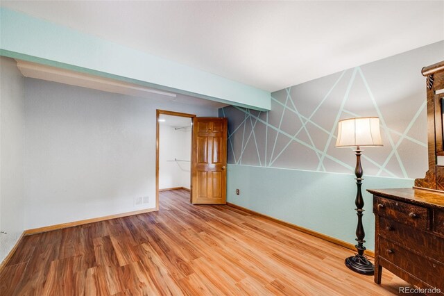 163 Ward Ct, Lakewood, CO 80228 - empty room featuring wood finished floors and baseboards