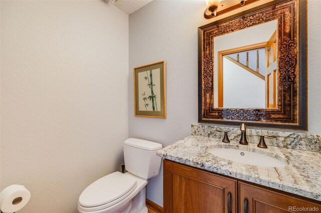 163 Ward Ct, Lakewood, CO 80228 - half bath featuring vanity and toilet