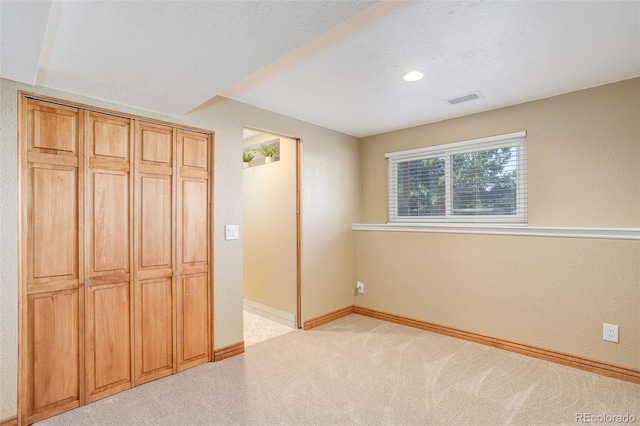 unfurnished bedroom featuring light carpet