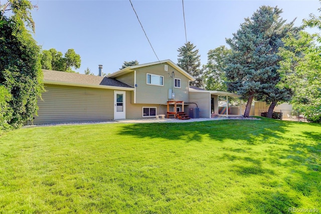 back of property with a yard and a patio