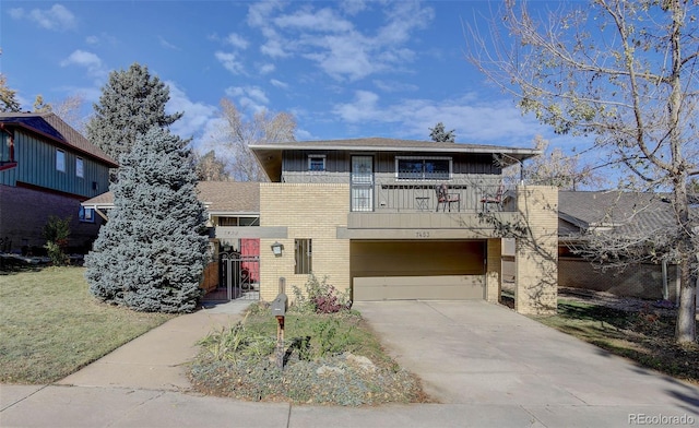 view of front of home featuring a balcony and a garage