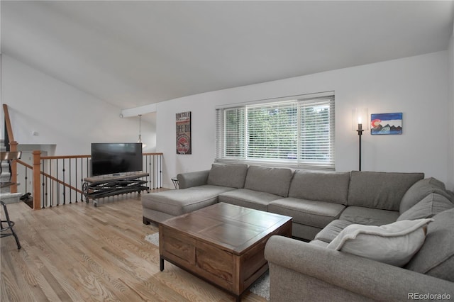 living room with light hardwood / wood-style flooring and lofted ceiling