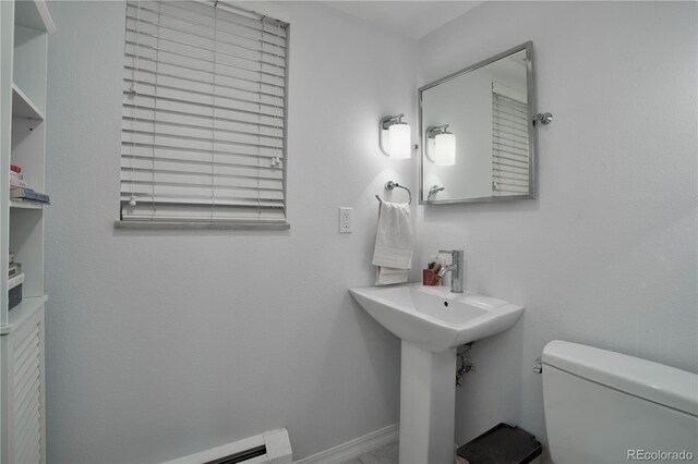 bathroom featuring toilet and a baseboard heating unit