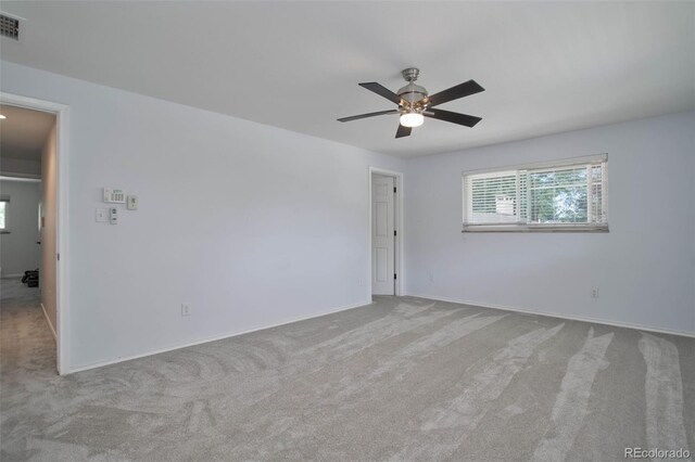 unfurnished room featuring light carpet and ceiling fan