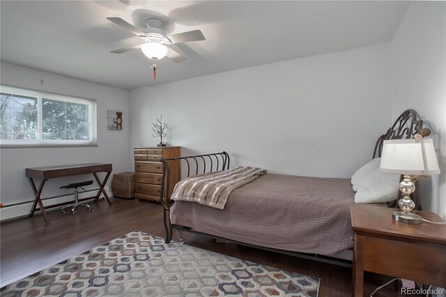 bedroom with hardwood / wood-style flooring, baseboard heating, and ceiling fan