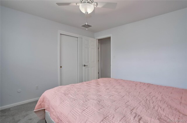 carpeted bedroom with ceiling fan and a closet