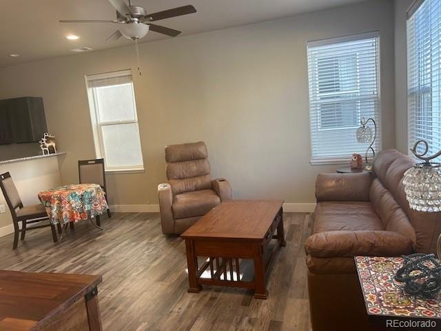 living room featuring wood-type flooring and ceiling fan