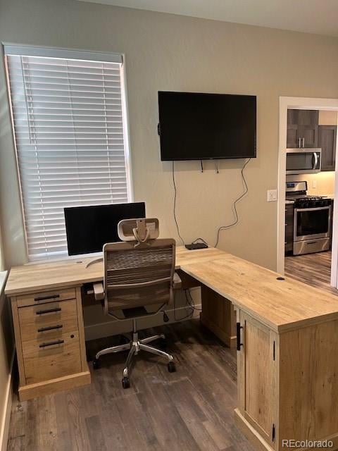 home office with dark hardwood / wood-style flooring