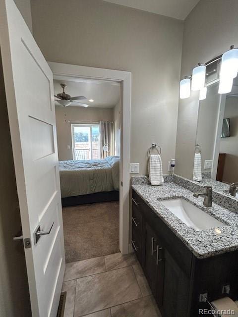 bathroom with tile patterned floors, vanity, and ceiling fan