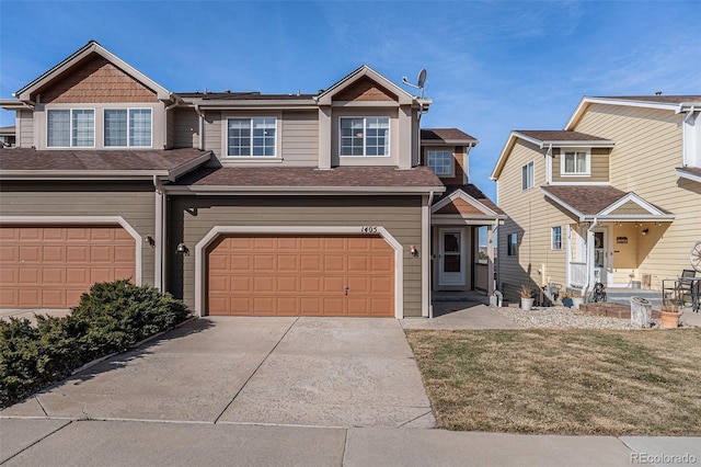 multi unit property featuring driveway, an attached garage, and a shingled roof