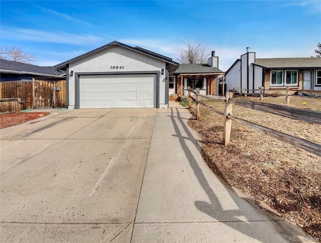 ranch-style home with concrete driveway, a garage, and fence