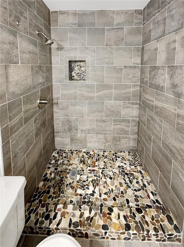 bathroom with tiled shower