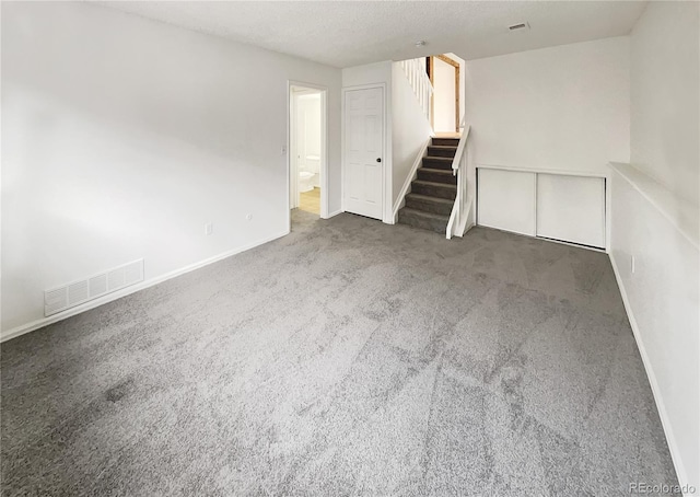 interior space featuring stairway, baseboards, and visible vents